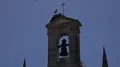 Stork nest on building with crucifix and bell zoom out in Faro, Portugal 4k or 4k+ Resolution