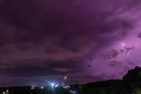 Storm and bright lightning strike at dusk at night Stock Photos