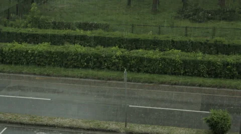 Storm and rain. Wind swallows trees. People and car run through the streets. Stock Footage 40063838