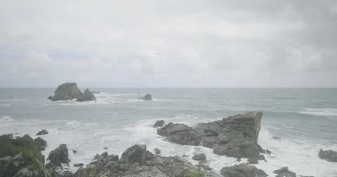 Storm approaches a Rugged Coast, Waves Crash Against Rocks, 4K Stock Footage 240453955