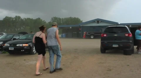 Storm blows dust over couple walking Stock Footage 7738467
