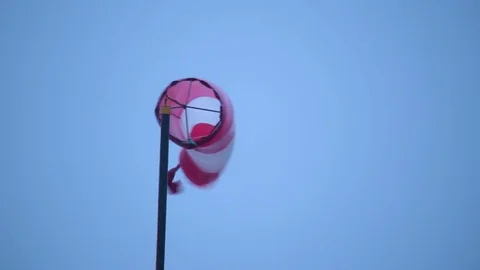 Storm brewing wind sock flapping in strong wind dark overcast Stock Footage 70774977