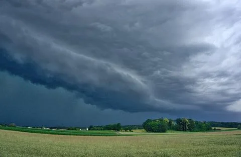 Storm cell formation extending over the harvested field Stock Photos