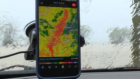 Storm chasing with weather radar and GPS in thunderstorm and flooding rain Stock Footage