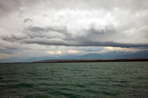 Storm cloud and rain clouds on the mountains and lake Stock Photos