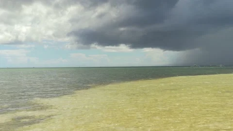 A storm cloud approaches a beach with turquoise waters, in the Philippines Stock Footage 235493153