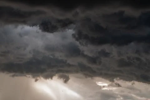 Storm cloud background before rain. Huge black clouds on sunset. Stock Photos