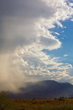 Storm cloud climbing and wrapping around a mountain, Cottonwood, Arizona. Stock Photos