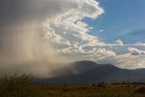 Storm cloud in the desert approaching a mountain, Cottonwood, Arizona. Stock Photos