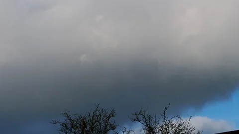 Storm cloud grey and white blowing in covering blue sky. Stock Footage 320549956