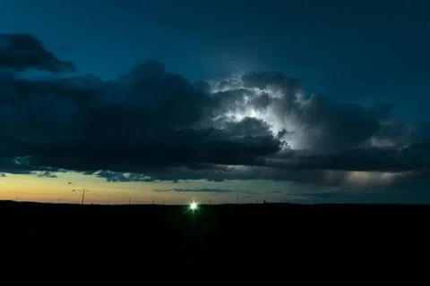 Storm cloud illuminated by lightning Stock Photos