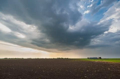 Storm cloud over the plains at sunset Stock Photos