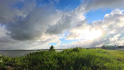Storm cloud time lapse casting shadows on bright sunlit grass Stock Footage 325660343