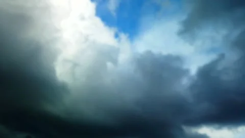 Storm Cloud Time Lapse gray and white swirling with an opening to blue sky Stock Footage 263921967