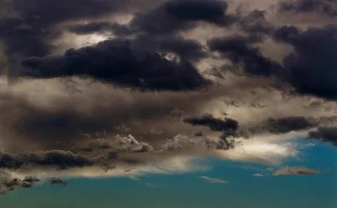 Storm cloude over city. Light in the Dark and Dramatic Storm Clouds. Backgrou Stock Photos