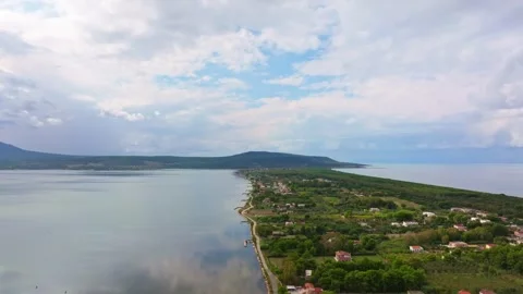 Storm clouds above Lago di Varano and the forested Adriatic shoreline. Stock Footage 334777601