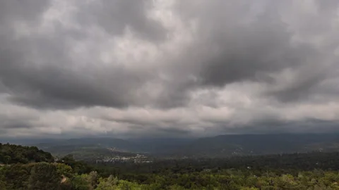 Storm Clouds above Mountain Town with Highway Traffic Time Lapse Stock Footage 280972791