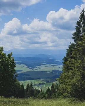 Storm Clouds Above Rolling Green Valley and Forested Mountain Landscape Photos