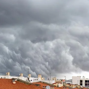Storm Clouds Above The Roofs Stock Photos
