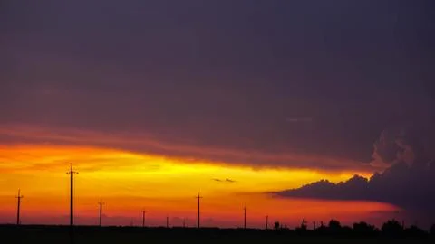 Storm clouds against the backdrop of an incredibly beautiful sunset Stock Photos
