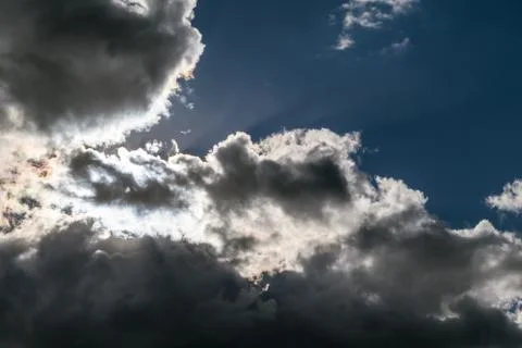 Storm clouds and the clouds overshadow the sun. Stock Photos