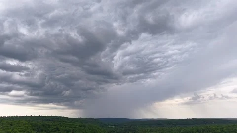 Storm Clouds and Distant Rain Above Forest in Chibougamau Quebec Vídeos de archivo 348779398