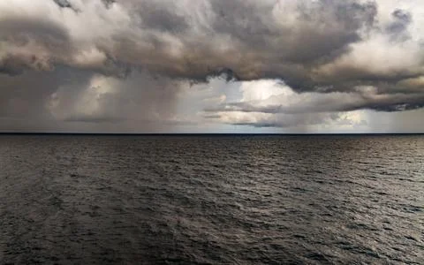 Storm clouds and rain over sea Fotos Stock