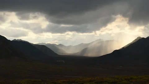 Storm clouds and sunlight moving over the dramatic landscape of the Klondike Riv Stock Footage 163161509