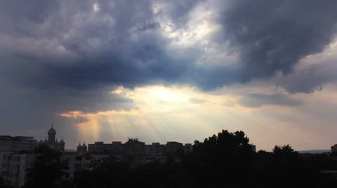 Storm clouds and sunset over the city silhouette Stock Footage 52956636