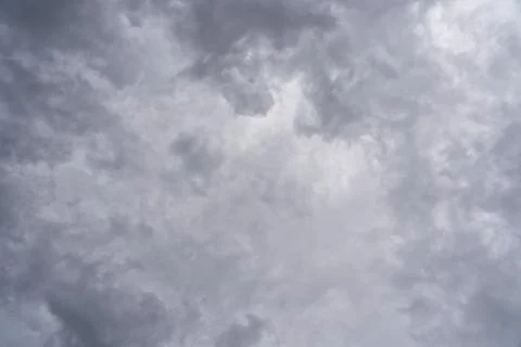 Storm clouds are clearing in the center to allow sunlight to penetrate Stock Photos