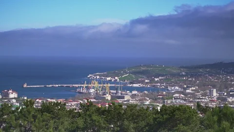 Storm clouds around the city over the sea near the port Stock Footage 107346357
