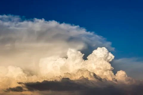 Storm clouds bathed in sunset light Stock Photos