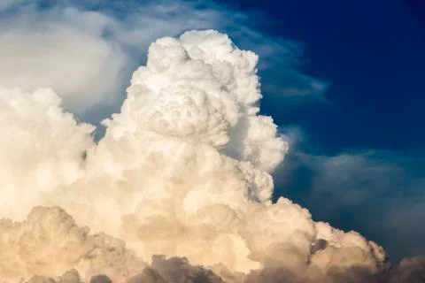 Storm clouds bathed in sunset light Stock Photos