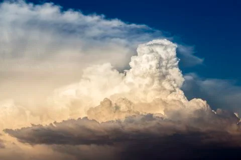 Storm clouds bathed in sunset light Stock Photos