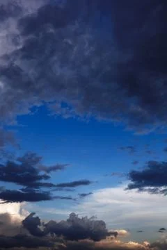 Storm clouds on the blue sky. Stock Photos
