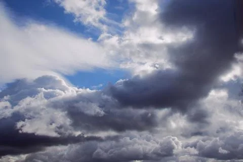 Storm clouds on a blue sky, torn textured clouds on a blue sky Stock Photos
