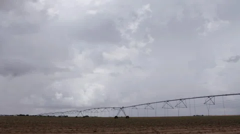 Storm clouds build and roil over an irrigation center pivot in the flat prairie  Stock Footage 51273731