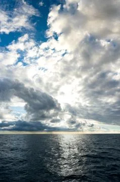 Storm clouds building up over dark blue ocean Stock Photos