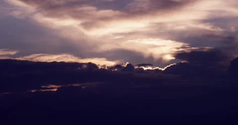 Storm clouds churn Sun behind 動画素材 243620509