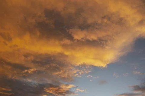 Storm clouds colored by setting sun Stock Photos