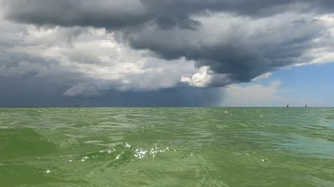 Storm Clouds coming into the green ocean water Stock Footage 160131450