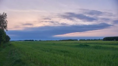 Storm clouds comming over fields in springtime sunset, Podlaskie Voivodeship, Stock Photos