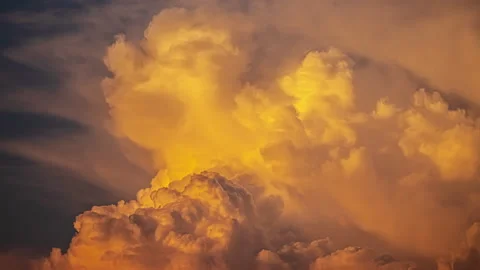 Storm clouds develop like an explosion in a darkening sky. Time Lapse Stock Footage 238747100