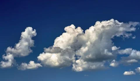 Storm clouds float across the blue sky Stock Photos