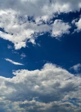 Storm clouds float across the blue sky Stock Photos