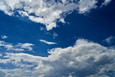 Storm clouds float across the blue sky Stock Photos