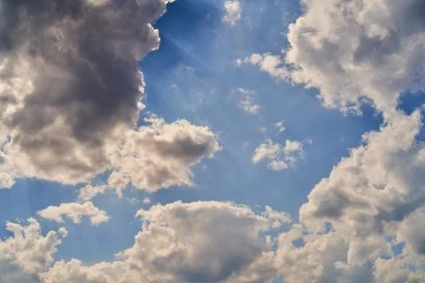 Storm clouds float across the blue sky Stock Photos