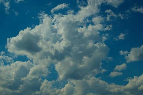 Storm clouds float across the blue sky Stock Photos