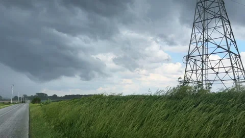 Storm clouds forming over a rural midwest road in summer Stock Footage 336564054