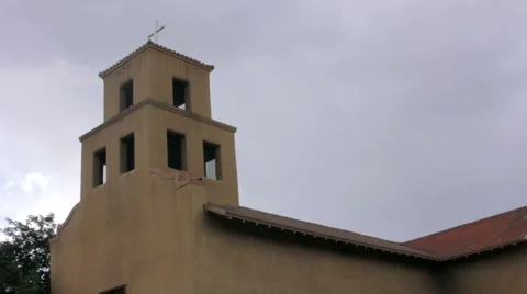 Storm Clouds Gather Behind an Historic Adobe Catholic Church Stock Footage 64826796